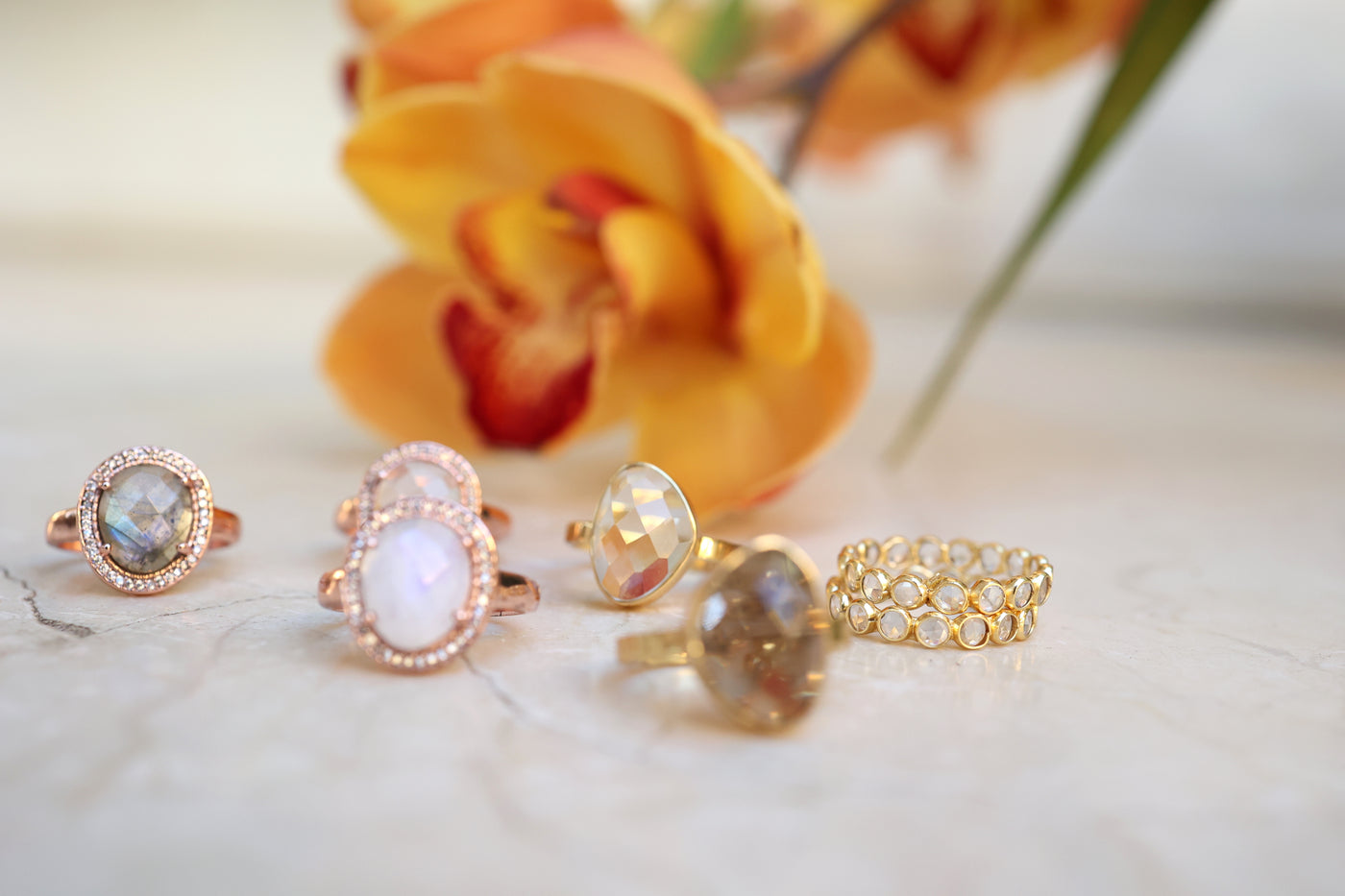 Sterling Silver and 14 carat gold plated gemstone rings photographed on marble setting