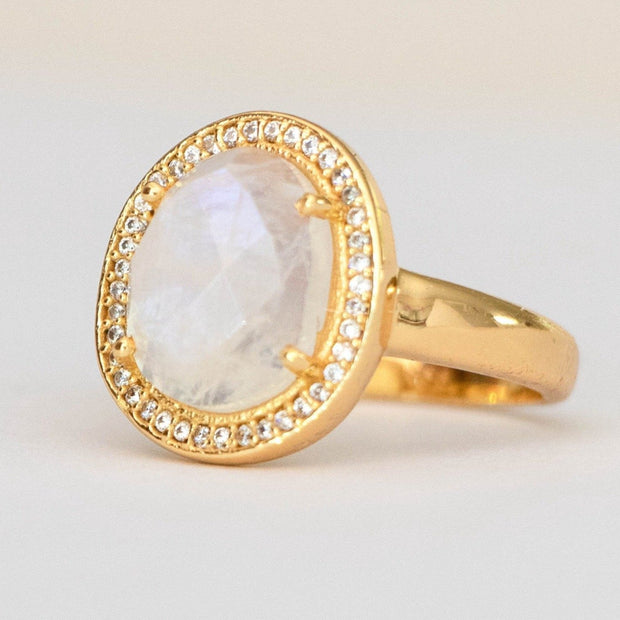 A beautiful solitaire Rainbow Moonstone stone that is surrounded by a halo of pave set cubic zirconias