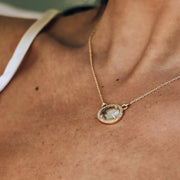 This beautiful pendant features a naturally shaped Green Amethyst semi-precious stone surrounded by a halo of pave set cubic zirconias. Set on a dainty adjustable gold plated chain