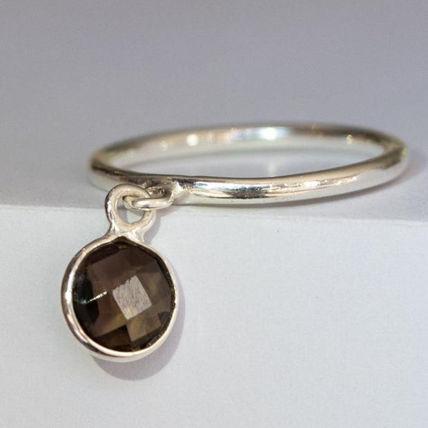 A round rose-cut Smokey Quartz stone set as a charm on a smooth sterling silver band. Elegant and playful - wear solo or add as a stacking ring addition. 