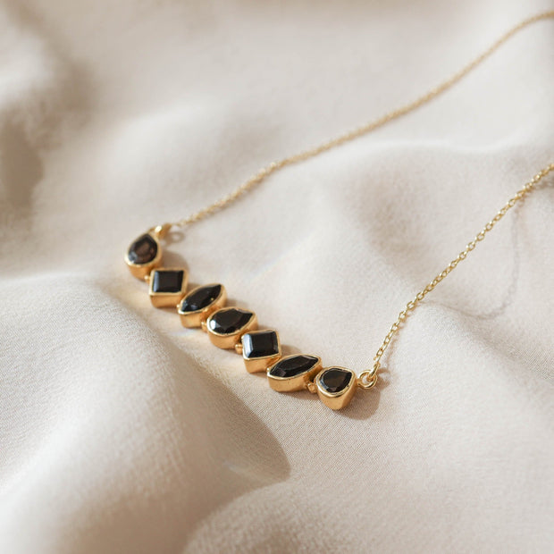 This unique Bar Necklace features a row of Smokey Quartz stones set in a bold bar style. Handmade in sterling silver and 14 carat gold plating