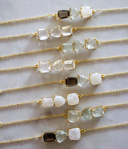 Three beautiful Crystal Quartz stones create a unique bar style bracelet, set on a dainty adjustable gold-plated chain