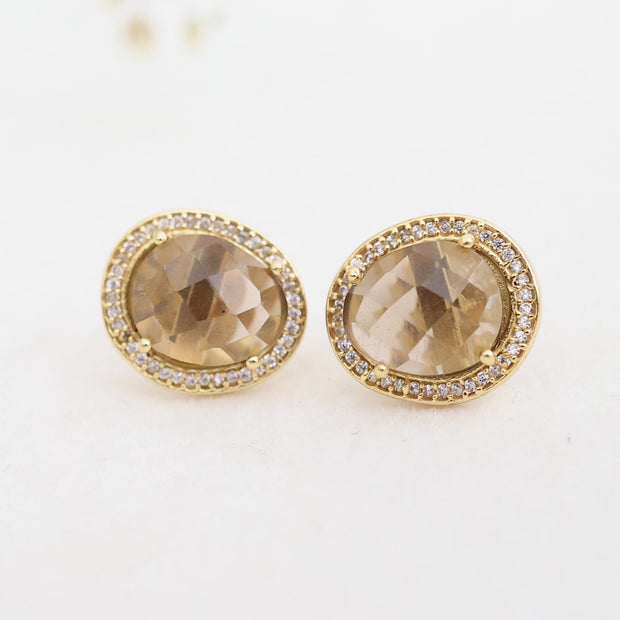 A pair of beautiful rose cut Smokey Quartz stones set in a pave halo and handmade in sterling silver and 14 carat gold plating - adding a subtle finishing touch to your day or night look