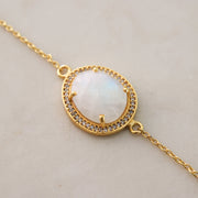 A beautiful Rainbow Moonstone is surrounded by a halo of pave set cubic zirconias set on a dainty adjustable gold plated chain