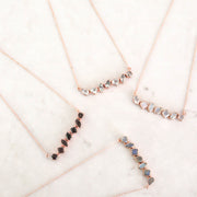 Our Smokey Quartz Bar Necklace features an array of semiprecious stones creating a bold bar style necklace 