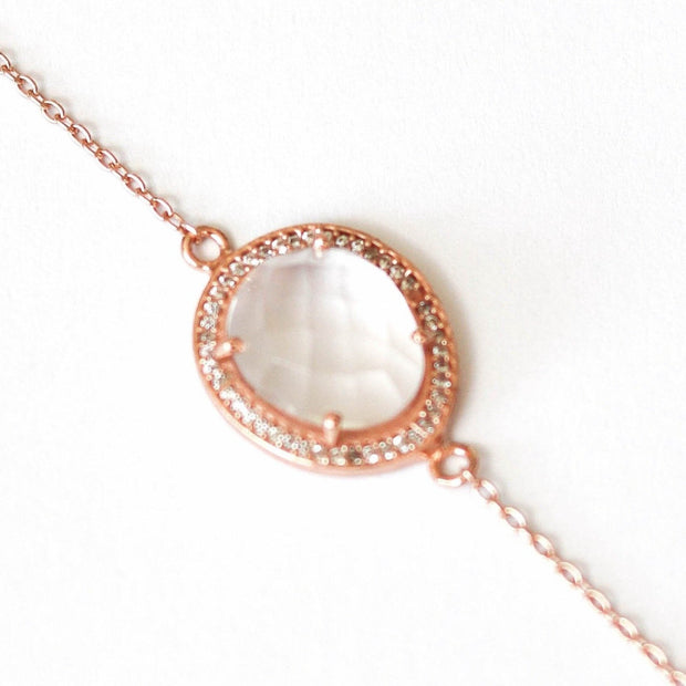 A beautiful Crystal Quartz stone surrounded by a pave halo of cubic zirconias set on a dainty adjustable 14 carat rose gold plated chain