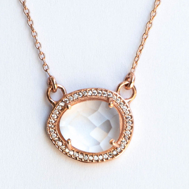 This beautiful pendant features a rose cut Crystal Quartz stone surrounded by a halo of pave set cubic zirconias. Set on a dainty adjustable 14 carat rose gold plated chain
