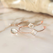 These charming hoop earrings are handmade in sterling silver and 14 carat rose gold plating and feature green amethyst semi-precious gemstones