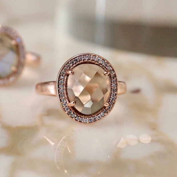 A beautiful solitaire Smokey Quartz rose cut stone is surrounded by a halo of pave set cubic zirconias