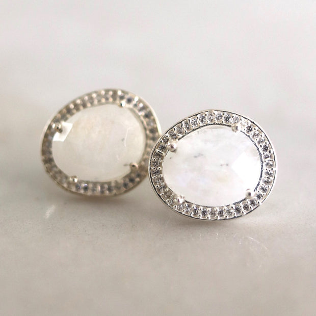 A pair of beautiful semi-precious Rainbow Moonstone stones set in a pave halo - adding a subtle finishing touch to your day or night look