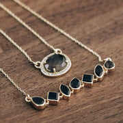 This beautiful pendant features a naturally shaped Smokey Quartz semi-precious gemstone surrounded by a halo of pave set cubic zirconias set on a dainty adjustable chain