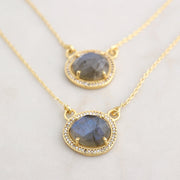 This beautiful pendant features a naturally shaped Labradorite semi-precious gemstone surrounded by a halo of pave set cubic zirconias set on a dainty adjustable sterling silver chain