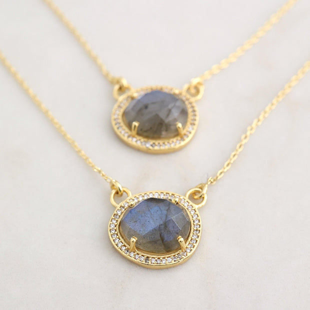 This beautiful pendant features a naturally shaped Labradorite semi-precious gemstone surrounded by a halo of pave set cubic zirconias set on a dainty adjustable sterling silver chain