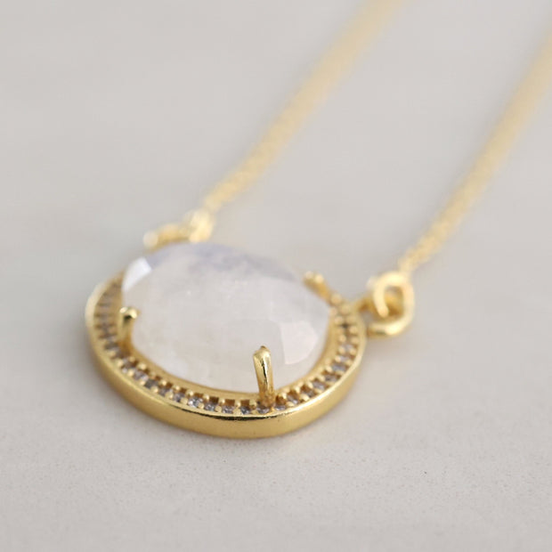 This beautiful pendant features a rose cut Rainbow Moonstone surrounded by a halo of pave set cubic zirconias set on a dainty adjustable chain