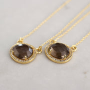 This beautiful pendant features a Smokey Quartz semi-precious stone surrounded by a halo of pave set cubic zirconias set on a dainty adjustable chain