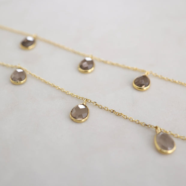 Three smokey quartz stones are delicately attached to a fine gold plated chain to create this elegant and easy to wear bracelet