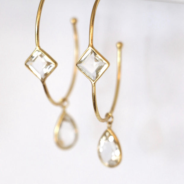 These charming hoop earrings are handmade in sterling silver and 14 carat gold plating and feature green amethyst semi-precious gemstones