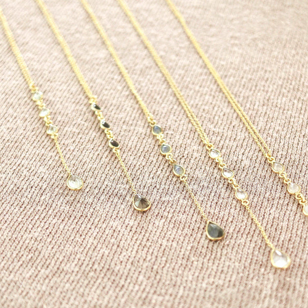 Dainty and elegant lariat necklaces feature four pear shaped gemstones in this design. Available in the semi-precious gemstone Labradorite